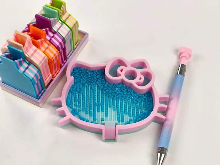 Blue diamond painting drills in a pink cat tray with a drill pen and colorful storage boxes for a tidy craft setup - FEELOOK Art