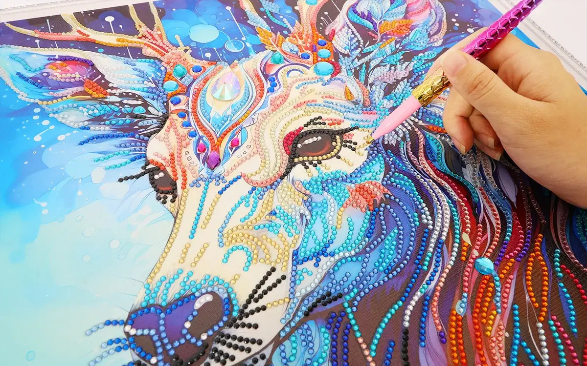 Hand placing drills on a detailed diamond painting canvas with focus on the artwork