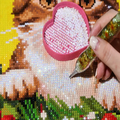 AB drills on the Christmas Kitten Wreath diamond painting with a hand placing diamonds and an AB diamond tray - FEELOOK Art