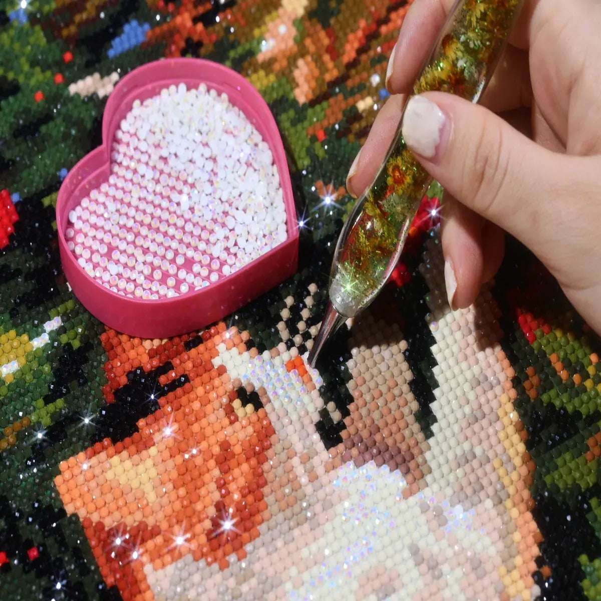 AB diamonds on the Kitten Party diamond painting with a hand placing diamonds and an AB diamond tray - FEELOOK Art