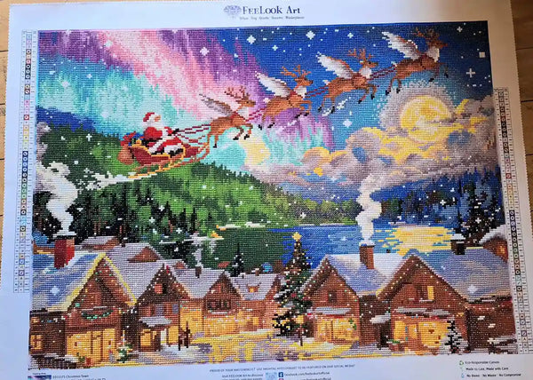 Finished Christmas Town diamond painting featuring Santa's sleigh, reindeer and a snowy illuminated village - FEELOOK Art