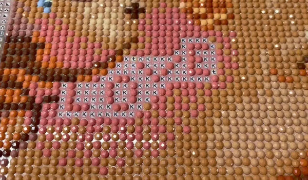 Close-up of round diamond painting drills being placed on a colorful canvas - FEELOOK Art