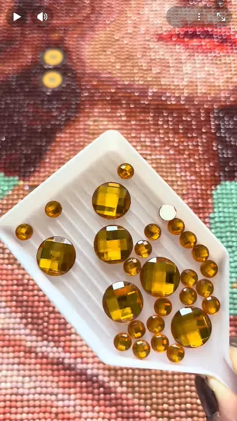 Gold faceted special drills displayed in a tray over a diamond painting canvas - FEELOOK Art