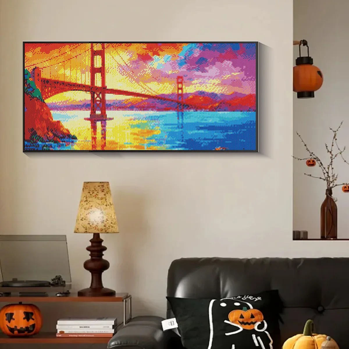 golden gate bridge diamond painting completed and hung above a modern sofa, perfect for DIY art enthusiasts.