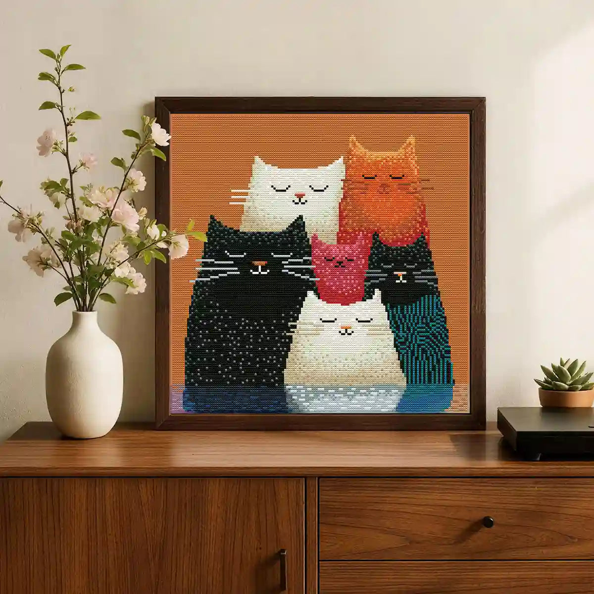 Kitty Squad diamond painting displayed on a wooden cabinet with a white vase - FEELOOK Art