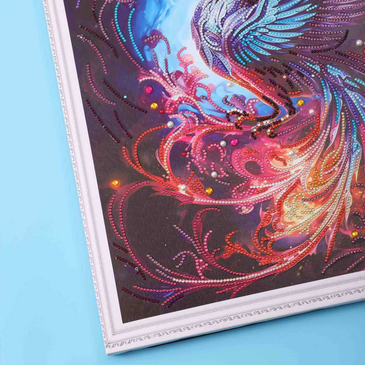 Detailed view of the Phoenix’s fiery wings and glowing colors with shimmering diamonds.