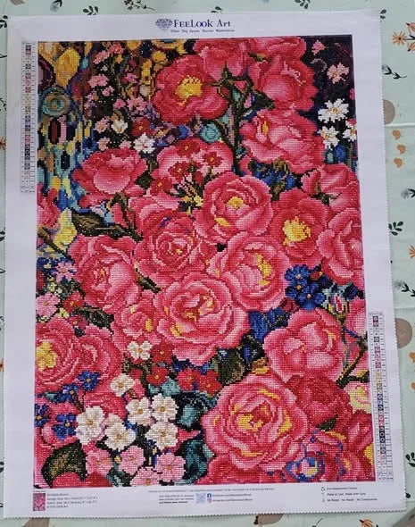 Finished floral diamond painting filled with vibrant pink roses and colorful blossoms - FEELOOK Art
