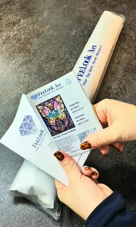 Customer showing the Prismatic Butterfly collector card and diamond painting kit during unboxing - FEELOOK Art