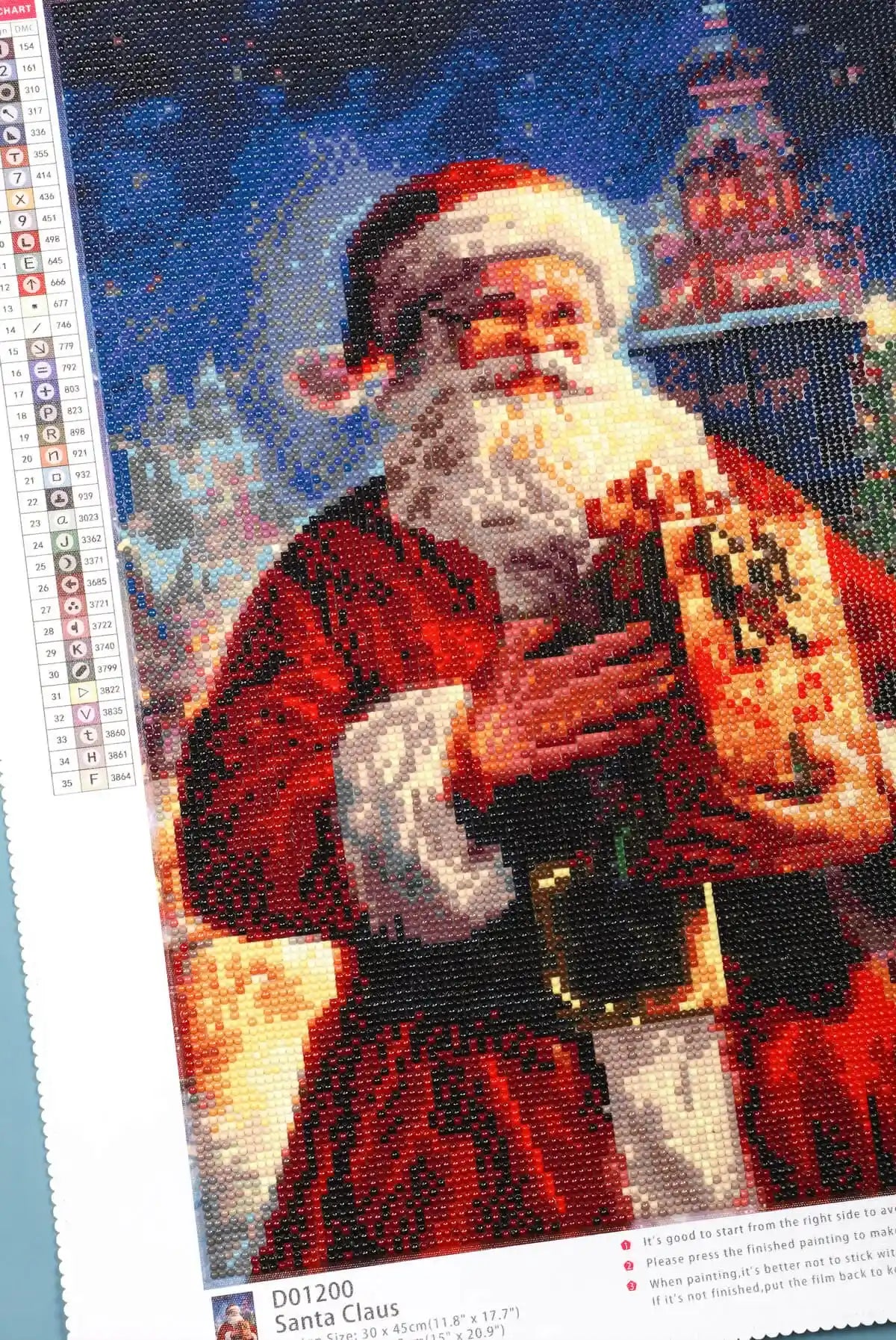 Detail of sparkling Christmas elements in Santa Claus diamond art.