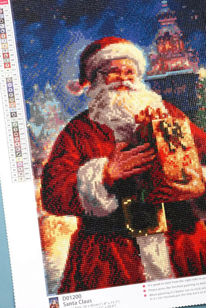 Detail of sparkling Christmas elements in Santa Claus diamond art.