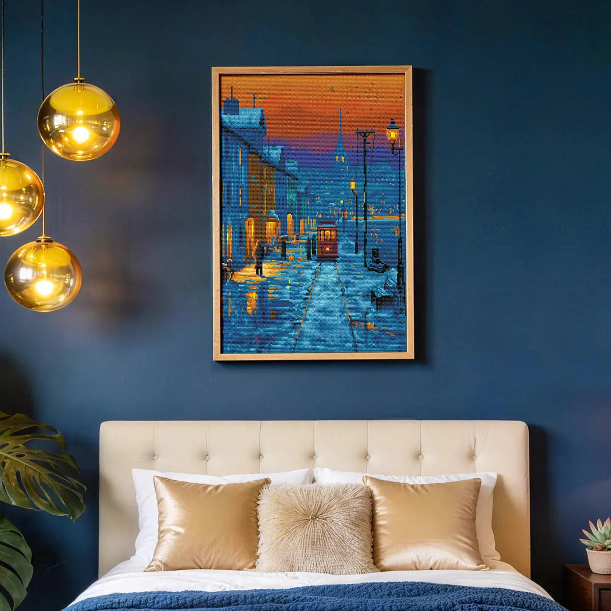 Snowy Street diamond painting hung on a dark blue wall above a bed with gold pillows - FEELOOK Art