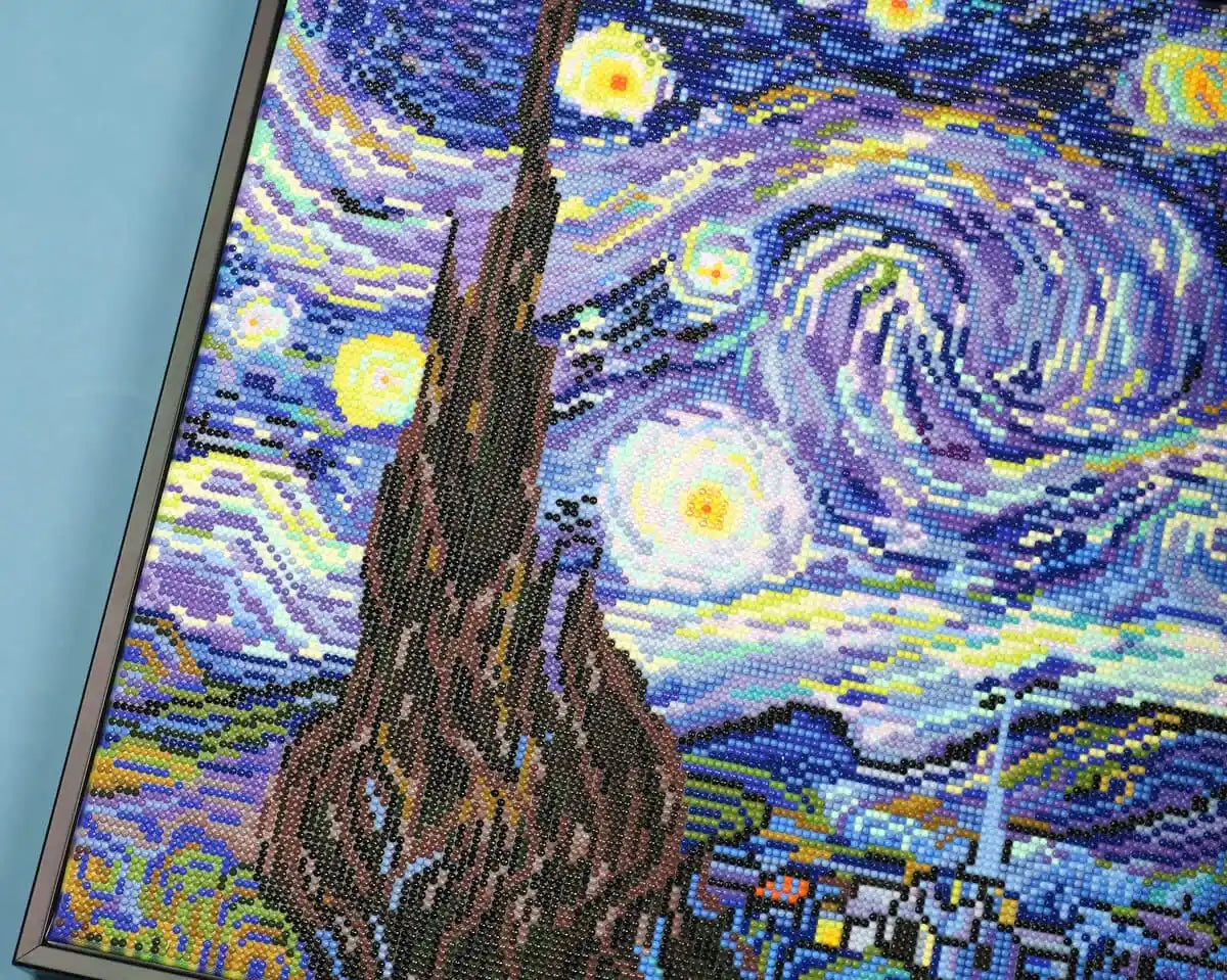 Detailed view of the moon and sky texture in The Starry Night artwork.
