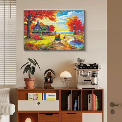 Fall landscape diamond art hung above wooden table in cozy interior.